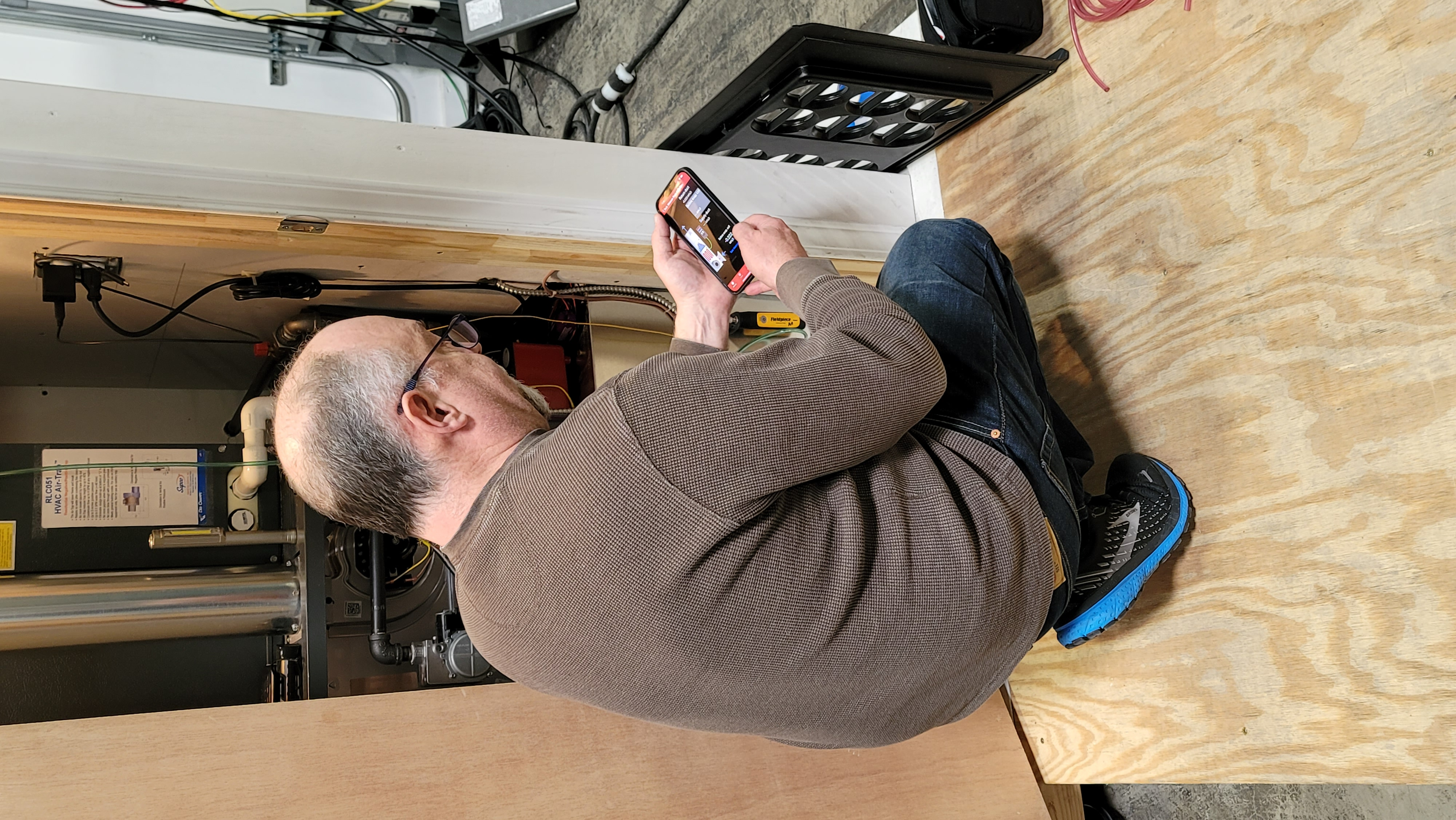 Technician using measureQuick app with TrueFlow grid installed for airflow measurement